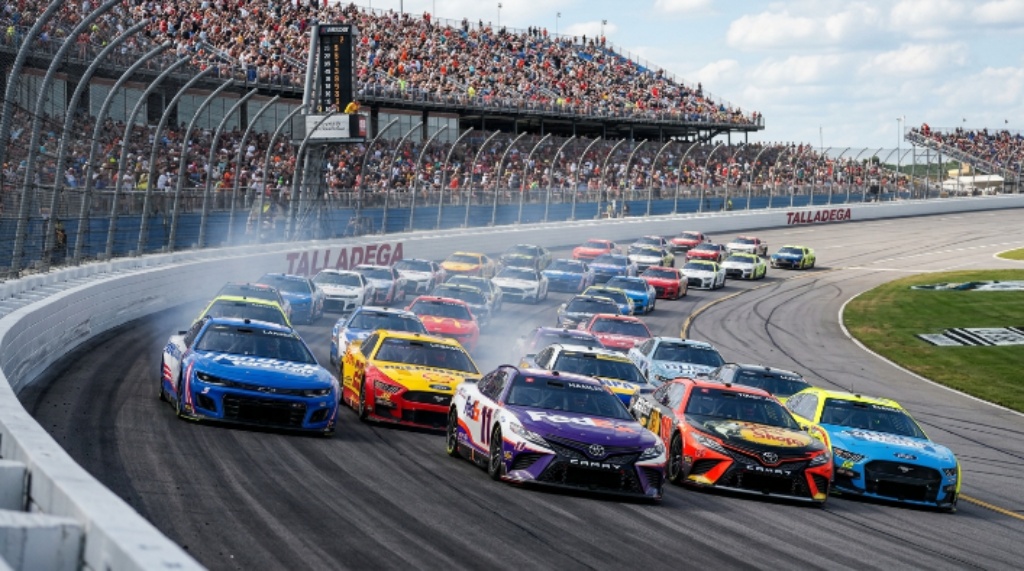 NASCAR Cup Series cars racing in a tight draft pack at Talladega